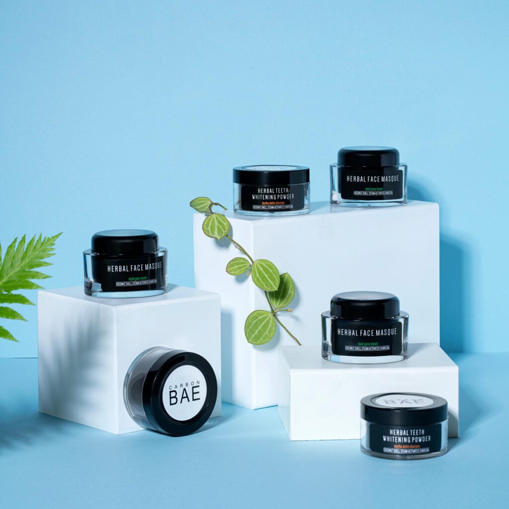 Carbon Bae herbal skincare jars on display blocks.