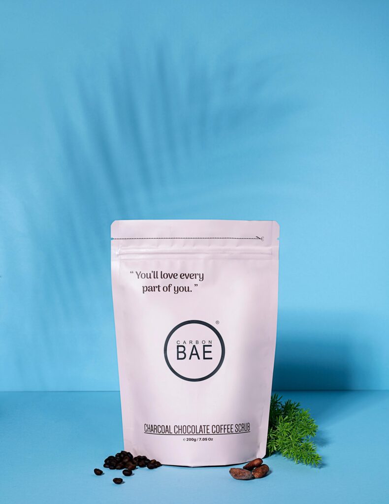 Carbon Bae scrub pouch on blue background.