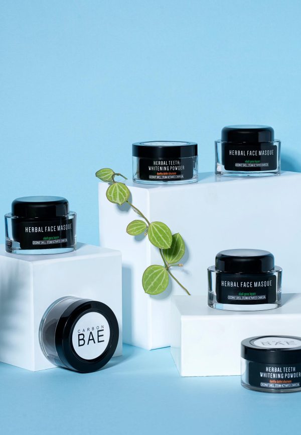 Carbon Bae herbal skincare jars on display blocks.